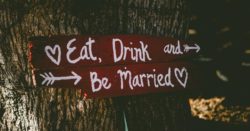 how to pay for a wedding without going broke; sign attached to a tree that reads eat, drink, and be married | Honor Credit Union