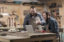 two men in a workshop looking at a laptop | Honor Credit Union