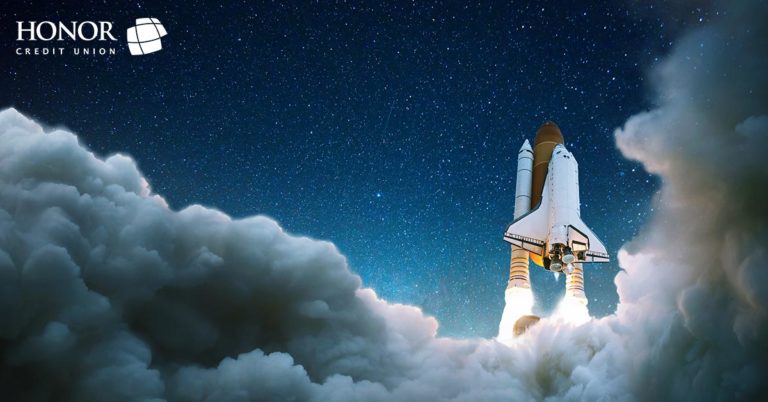 Image of a space ship launching off into a night sky with smoke from the rocket all around the bottom and right side of the image.