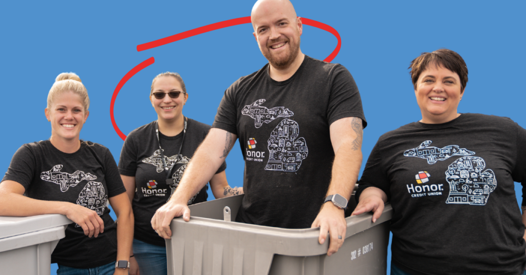 Honor team members at a shred day event with a team member popping out of a recycling bin