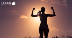 honor credit union can help you create a plan to save money; woman flexing her muscles in a sunset | Honor Credit Union