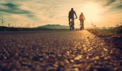 Cyclists on the sunset road | Honor Credit Union