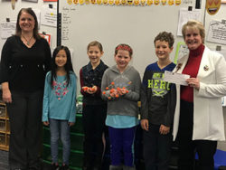 Honor's Tanya Urias presenting St. Joseph Public School's Mrs. Jarvie and students with $100 Teacher Award | Honor Credit Union
