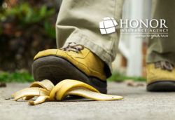 man wearing yellow shoes stepping onto used banana peel on sidewalk, honor insurance agency logo | Honor Credit Union