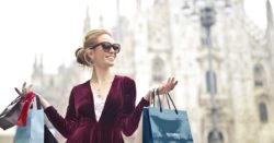 know when and where to buy foreign currency, and why it's important to know exchange rates; photo of woman shopping in a foreign country | Honor Credit Union