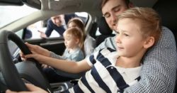 car truck down payment; father and son in driver's seat of new car | Honor Credit Union