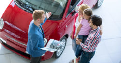 new auto loans at honor credit union enjoy no payments for 90 days; photo of family at car dealership | Honor Credit Union