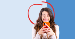 women looking at her phone smiling | Honor Credit Union