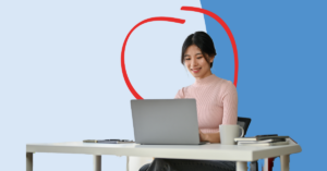 women looking at her laptop smiling | Honor Credit Union