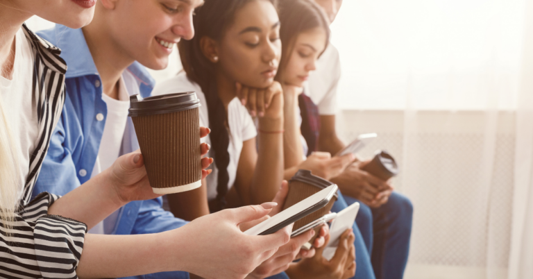 young people on their phones using social media | Honor Credit Union | Honor Credit Union