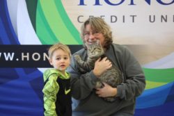 honor adoption day a big success at berrien county animal control on november 16, 2019; mom and son pose for photo with newly adopted cat