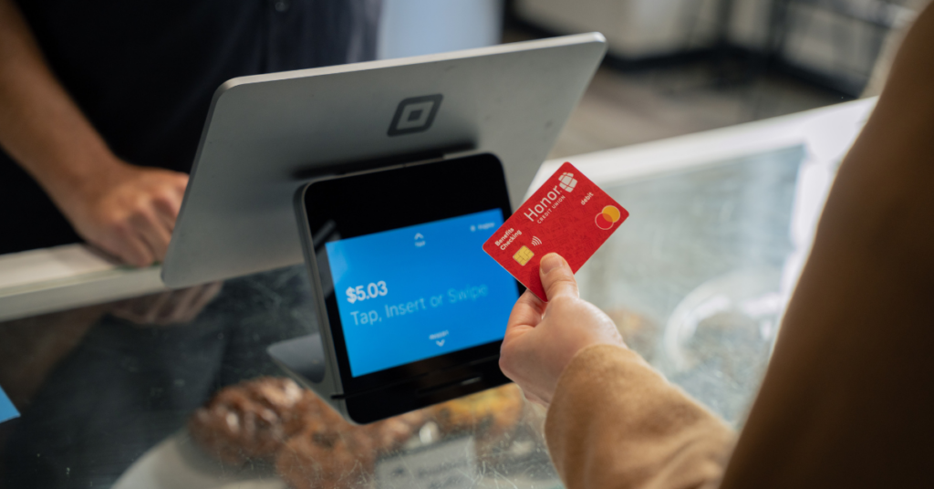tapping an Honor credid card on an ipad payment system | Honor Credit Union