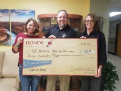 honor credit union community assistant vice president jamie gollakner presents a check to the Jacobetti Home For Veterans organization