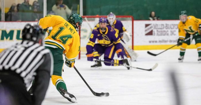 a northern michigan hockey player shoots the puck against minnesota state; honor credit union partners with NMU to donate money for each goal scored at home hockey games