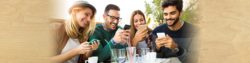 send anyone money for free in the honor credit union mobile app or in online banking; photo of group of friends looking at their phones | Honor Credit Union