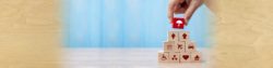 protect the people and the things you love the most with honor insurance; photo of a hand stacking blocks on a table | Honor Credit Union