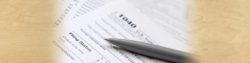 photo of a 1040 tax form with a pen resting on top of it | Honor Credit Union