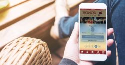 log in to the honor credit union app using a pin, fingerprint, facial recognition, voice, or a traditional password; image of a hand holding the honor app using the fingerprint login method | Honor Credit Union