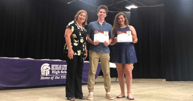 honor credit union will award 24 scholarships worth $1,00 each to graduating high school seniors; photo of 2019 winners being presented their scharships