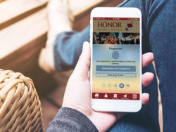 logging in to the honor app is simple with biometric authentication; photo of a hand holding a mobile phone with the honor credit union mobile app open | Honor Credit Union