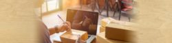 image of a person addressing a box to be mailed out while standing near a desk | Honor Credit Union