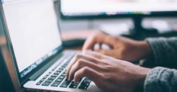 image of a person's hands typing on a laptop | Honor Credit Union