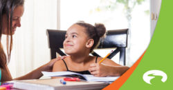 woman and daughter smiling at each other at a table | Honor Credit Union