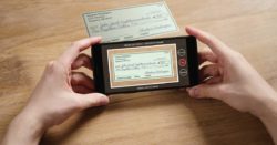 photo of someone taking a picture of a check using their mobile phone | Honor Credit Union