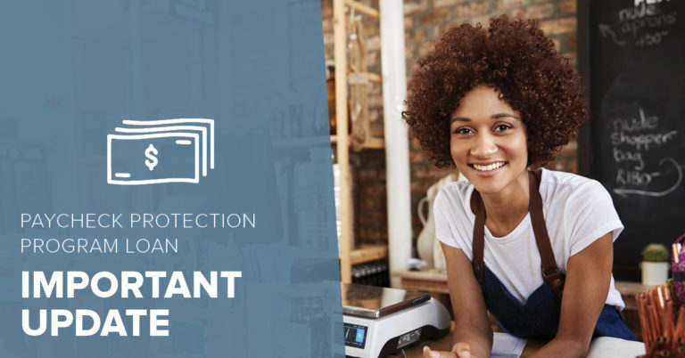 african american small business owner leaning over checkout counter
