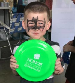 boy holding green frisbee | Honor Credit Union
