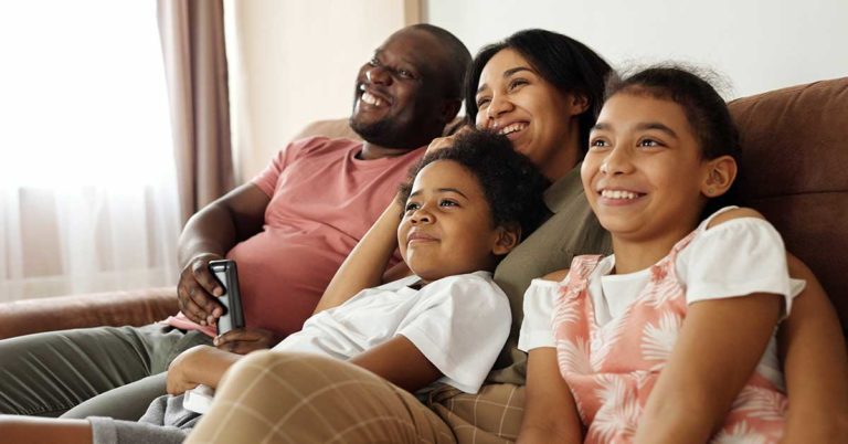 family of four relaxing on a couch