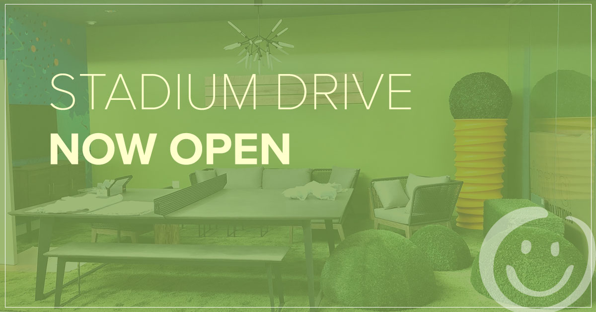 image of a lounge area with a green color overlay and white text that reads Stadium Drive now open