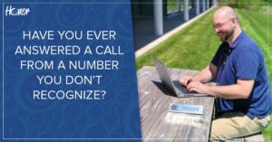 photo of honor cyber security analyst william crooker sitting outside at a picnic table smiling and working on his laptop | Honor Credit Union
