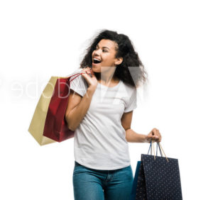 woman holding shopping bags smiling | Honor Credit Union