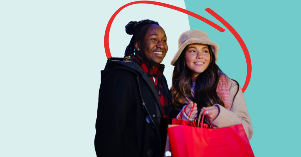 you women smiling and holding shopping bags
