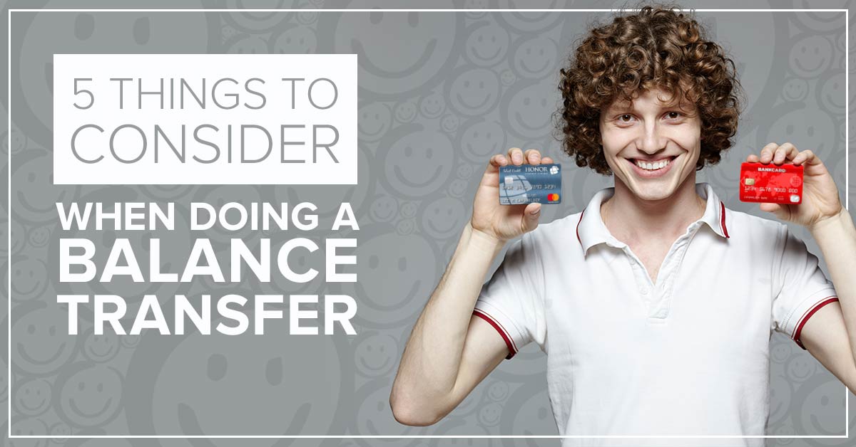 image of a man with curly brown hair smiling while holding up an honor credit union credit card in one hand and a bank credit card in the other hand with text on the image that reads 5 things to consider when doing a balance transfer