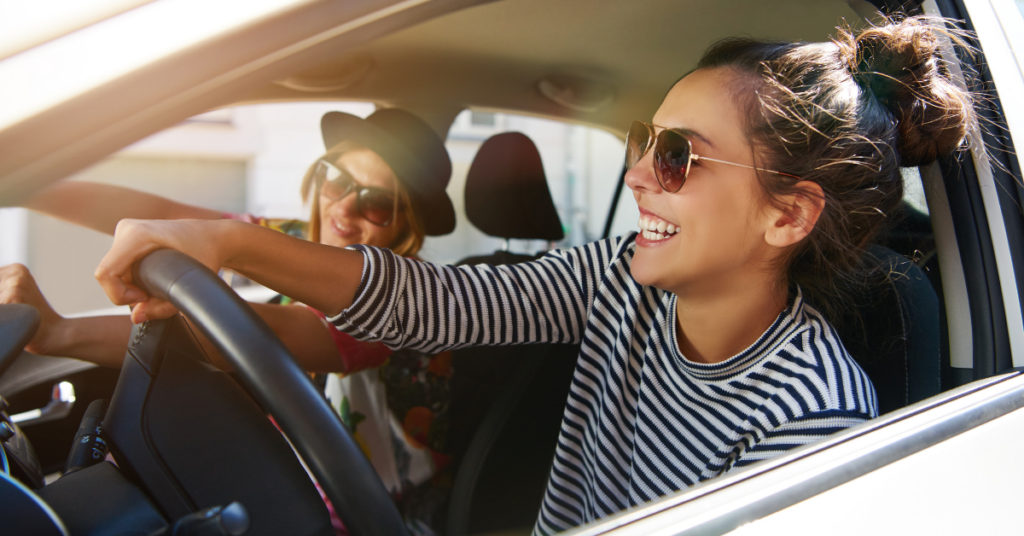 women driving a car with her friend | Honor Credit Union