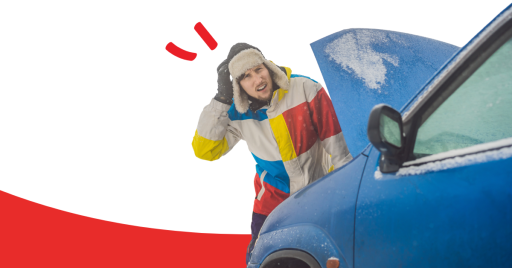 man in winter hat and coat with his broken-down car