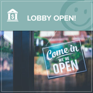 photo of doors with a sign hanging that reads come in we're open | Honor Credit Union