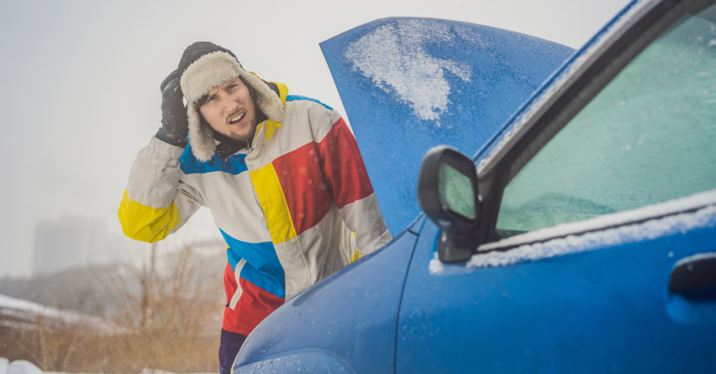 man in winter hat and coat with his broken-down car | Honor Credit Union