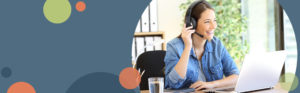 photo of a woman smiling and wearing a phone headset while sitting at a desk with a laptop; photo is on a light blue background with orange and green circles | Honor Credit Union