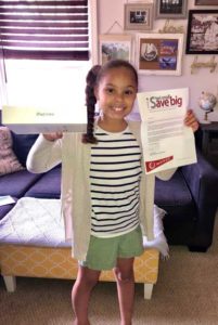 photo of a student holding an iPad she won through the honor credit union student credit union program | Honor Credit Union