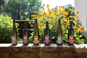 photo of various Round Barn wines on a brick wall | Honor Credit Union