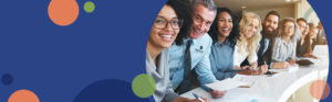 image featuring a blue background with green and orange circles on the left side and a photo of people smiling and standing at a table on the right side | Honor Credit Union