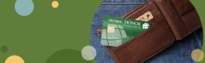 image featuring a green background with teal and yellow circles on the left with a photo of a select rewards credit card sticking out of a wallet on the right side | Honor Credit Union