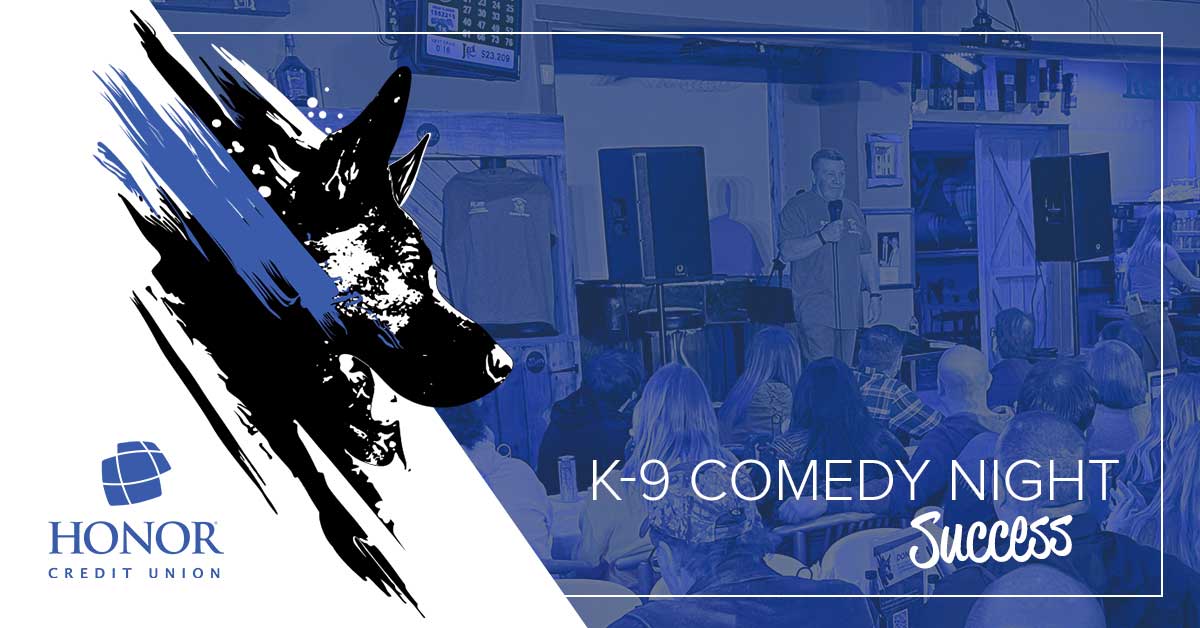 image of people sitting in a bar watching a comedy show with a blue color overlay with text that reads K-9 Comedy Night Success