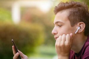 photo of a teenage boy looking at a mobile phone | Honor Credit Union