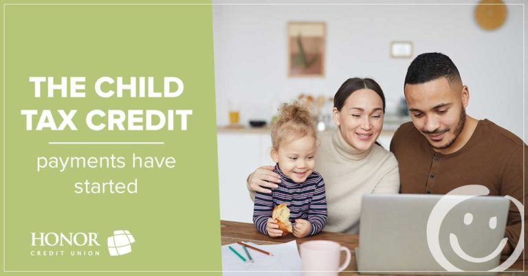 image featuring a photo of a family looking at a laptop on the right side of the image with text on a green background on the left side of the image that promotes an informational child tax credit blog post