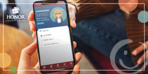 photo of a person's hand holding a smartphone with the screen displaying the honor credit union mobile app | Honor Credit Union