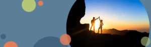 silhouette of two people high-fiving on a rocky peak during a sunset | Honor Credit Union